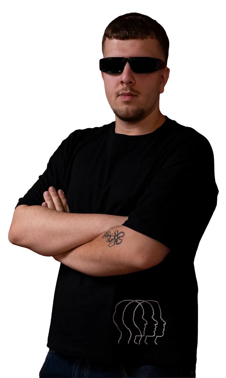Milli with arms crossed against a red backdrop